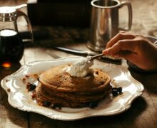 pancake with butter on white ceramic plate